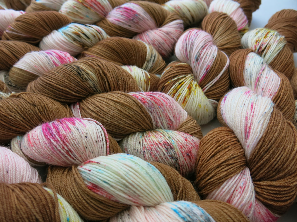 indie dyed brown and pink speckled yarn skeins