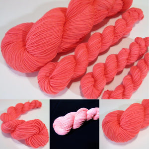 hand dyed solid neon coral yarn fluorescing under uv black light