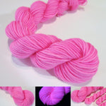 hand dyed cotton candy pink yarn fluorescing under uv black light