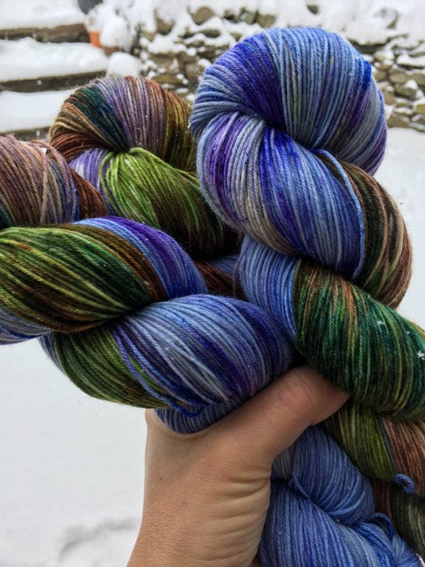 blue indie dyed merino sock yarn with a flower theme