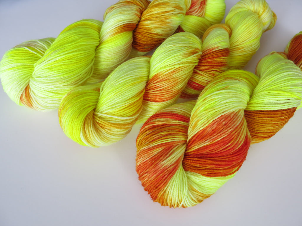 indie dyed yellow uv reactive sock yarn skeins