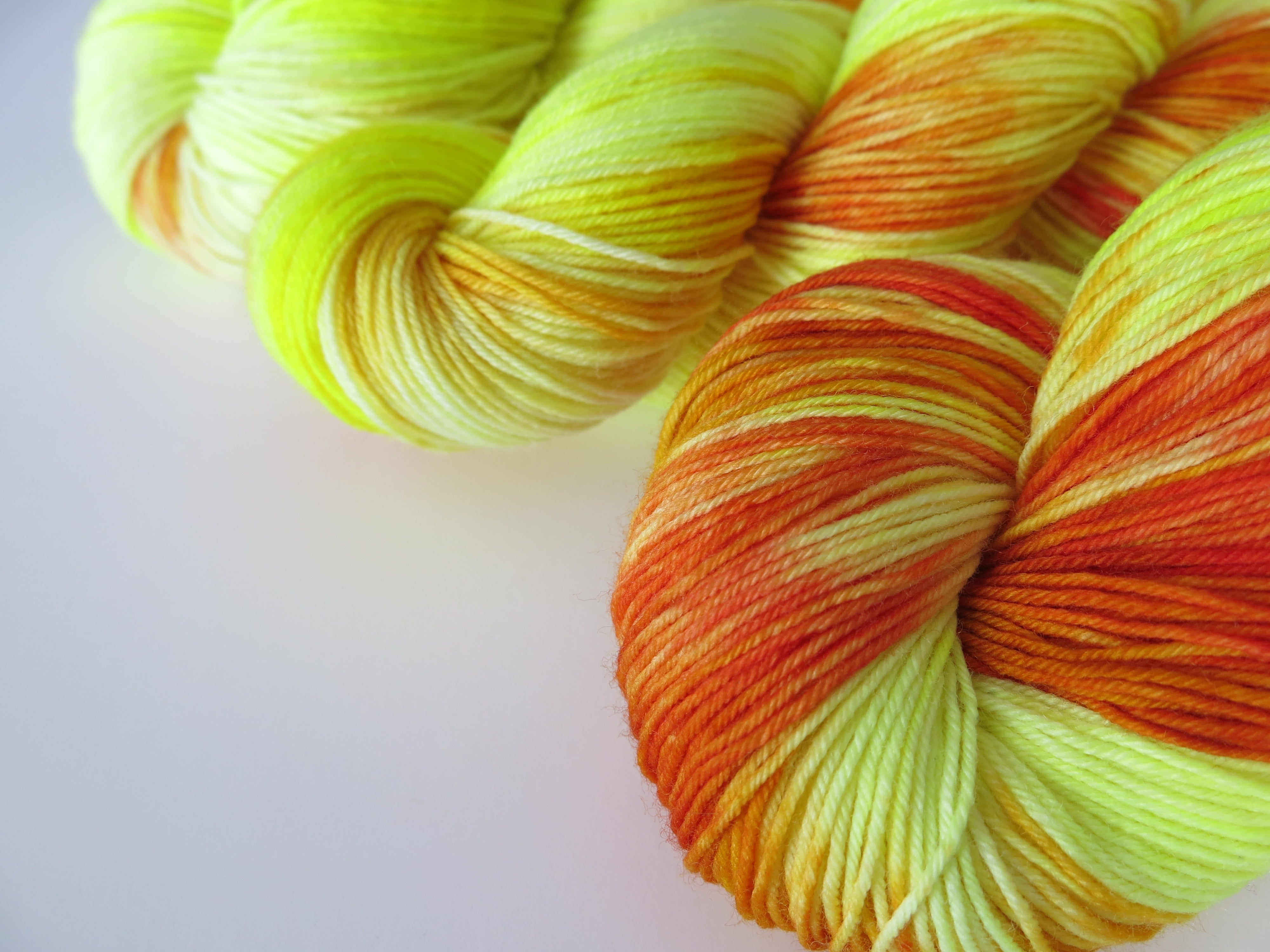 hand dyed merino and nylon sock yarn skeins in yellow and orange