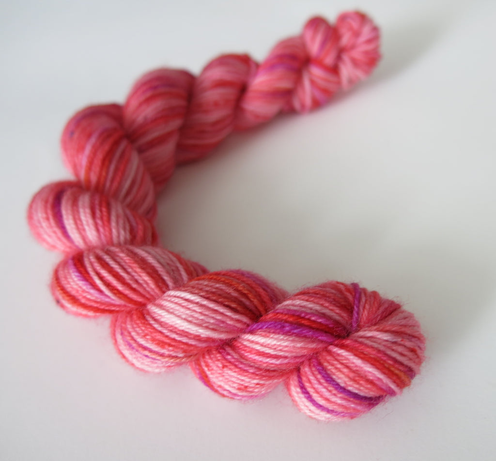 indie dyed pink and red sock yarn for knitted memory blankets