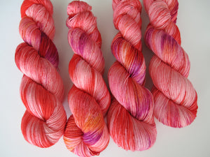 indie dyed pink and red sock yarn for knitting and crocheting socks