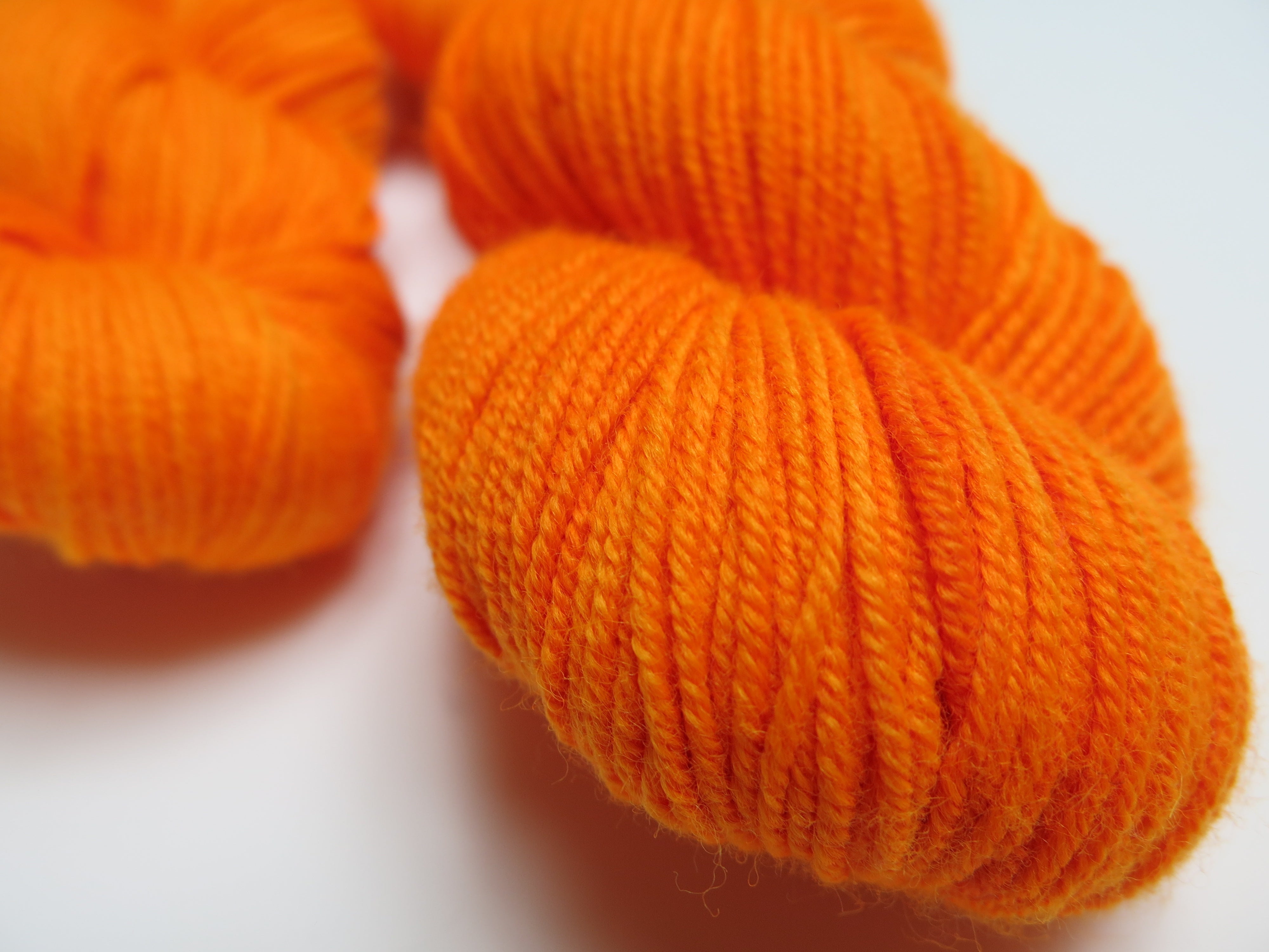 hand dyed uv reactive solid orange merino dk yarn