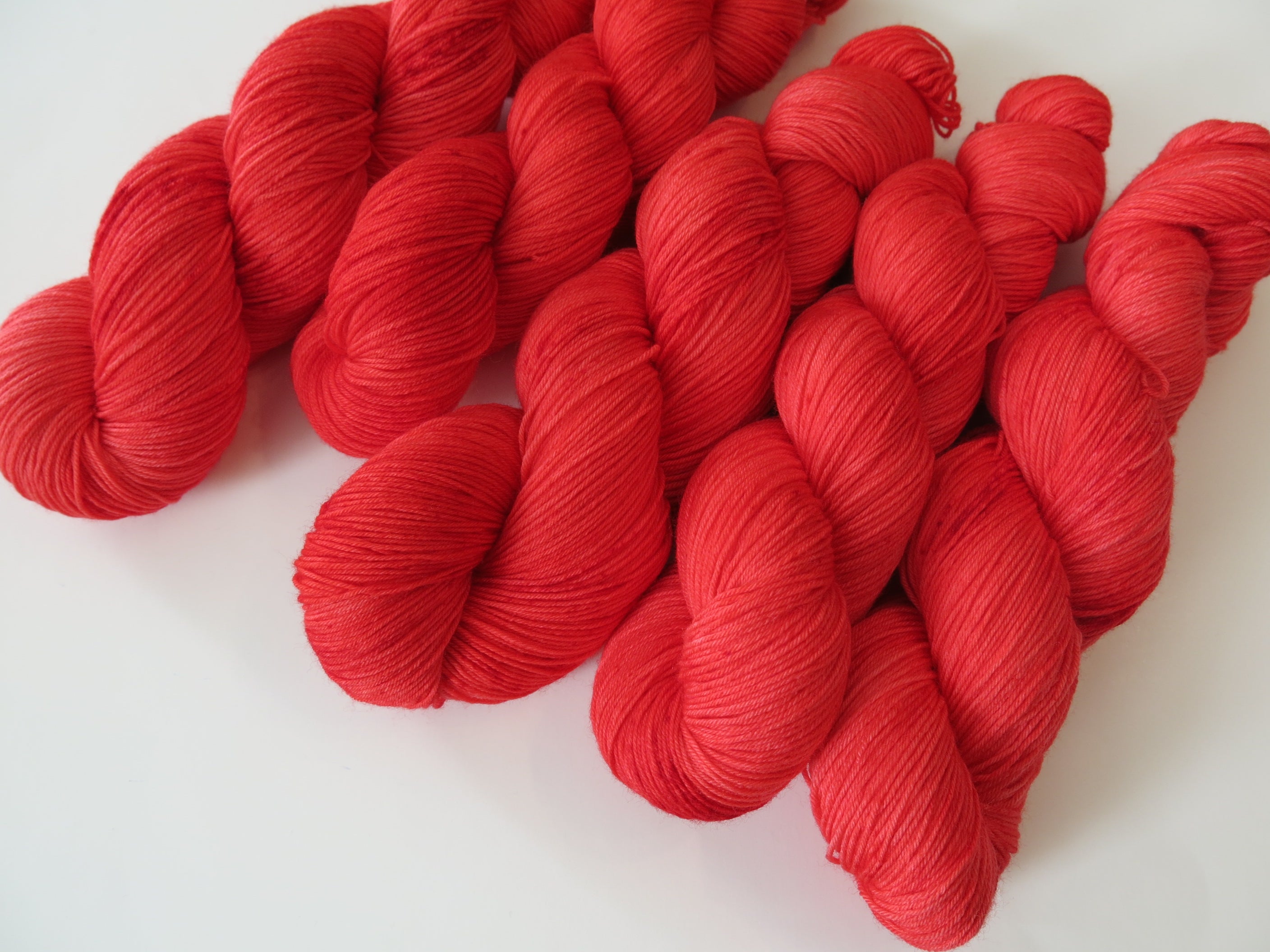 hand dyed wizard of oz ruby red merino sock yarn skeins