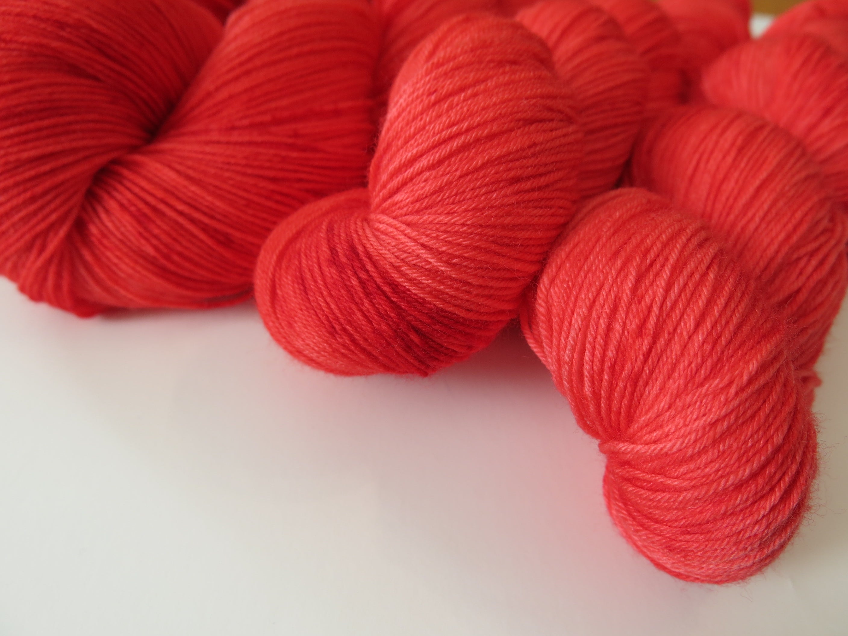 indie dyed ruby red merino sock yarn skeins