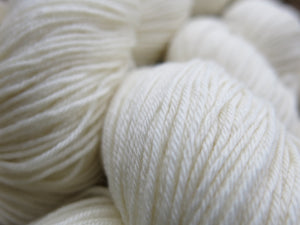 ecru undyed superwash merino and nylon sock yarn skein