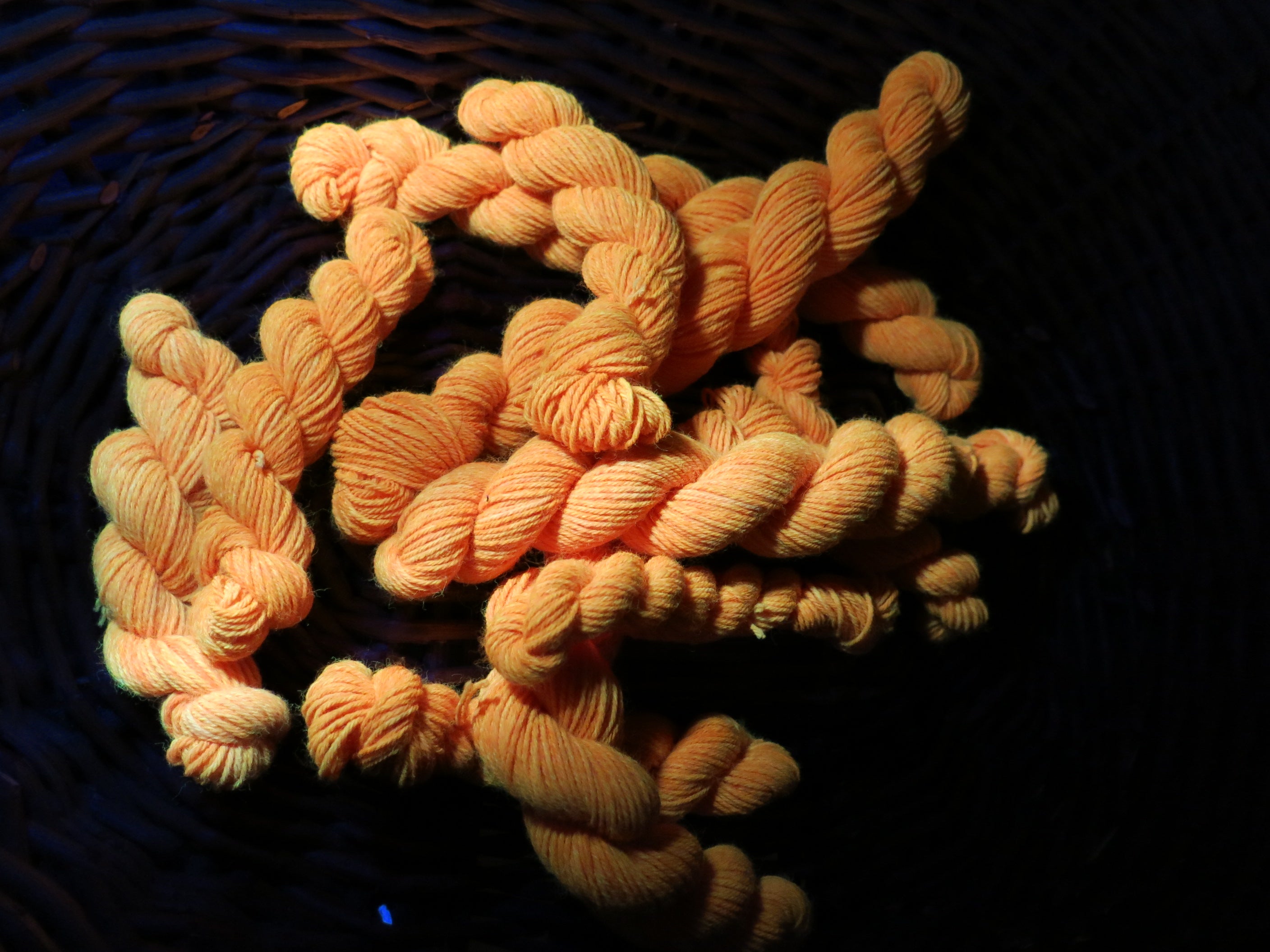 hand dyed orange uv reactive sock yarn mini skein under black light