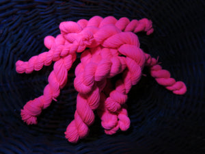 hand dyed pink uv reactive sock yarn mini skein under black light