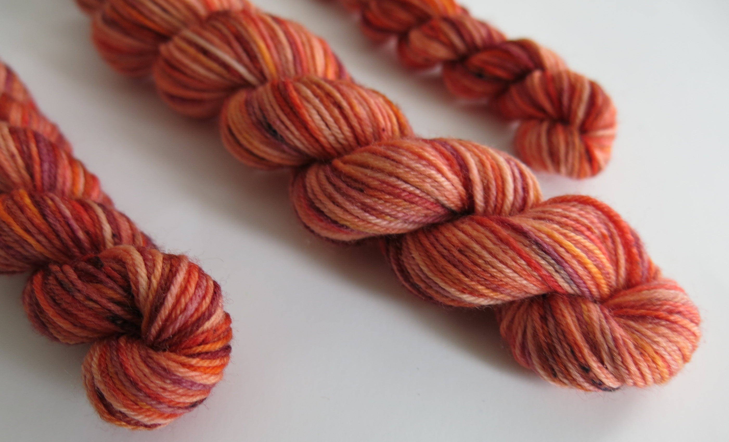 indie dyed uv reactive orange speckled sock yarn