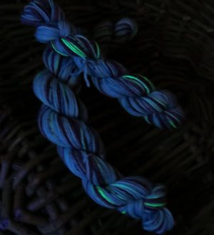 hand dyed superwash merino sock yarn mini skein under uv black light