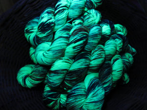 indie dyed uv reactive green yarn glowing under black light