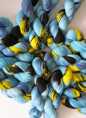 indie dyed blue and yellow superwash merino sock yarn skeins