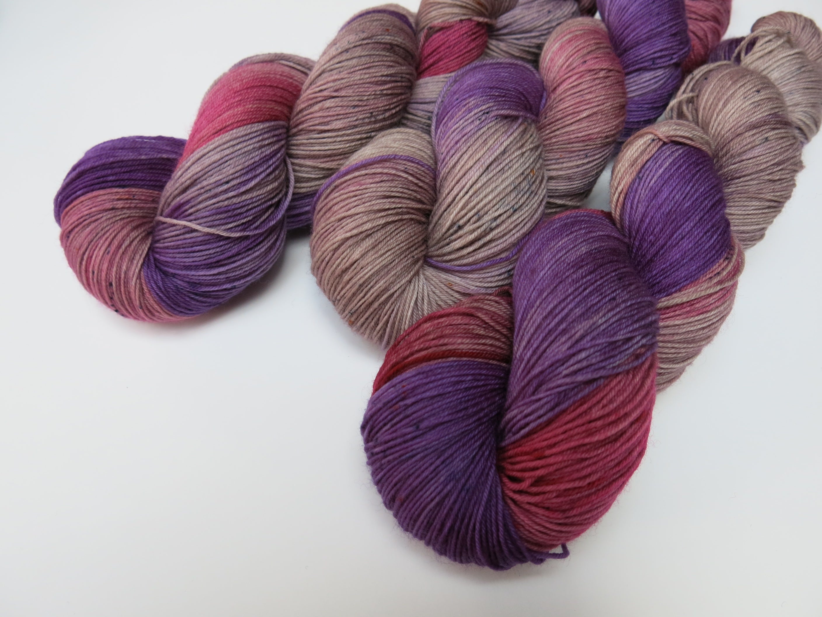 indie dyed yarn in purple and pink with speckles
