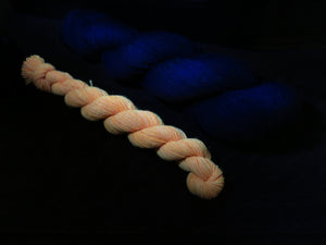 indie dyed black light responsive orange sock yarn skein