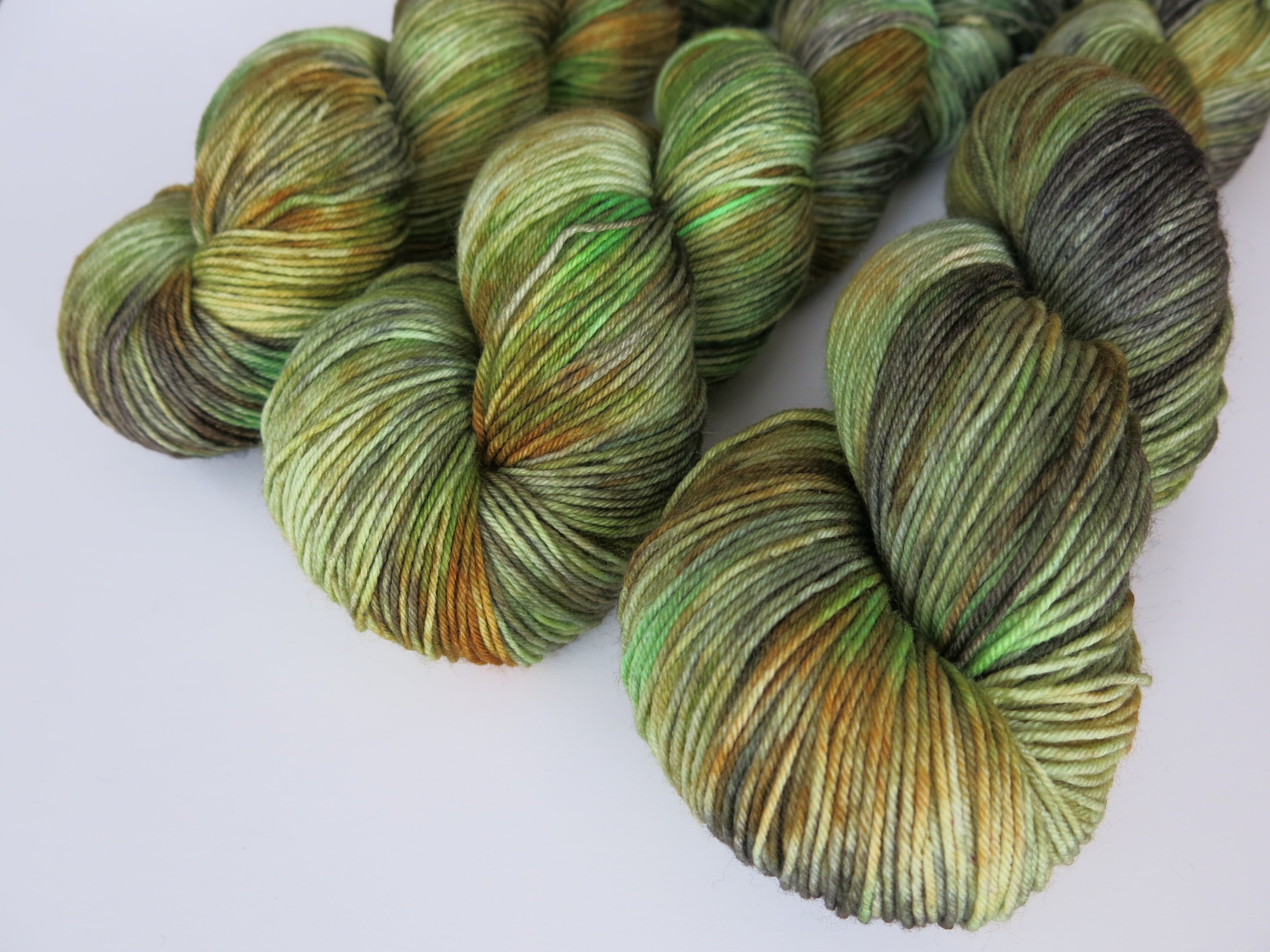 kettle dyed green and brown sock yarn skeins for knitting and crochet