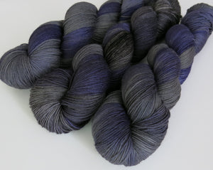 hand dyed tonal grey and purple sock yarn skeins