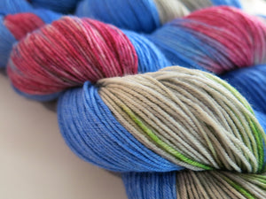 indie dyed sock yarn skeins in blue, pink, green and grey