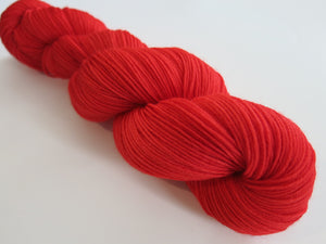 solid red merino sock yarn skein for knitting and crochet