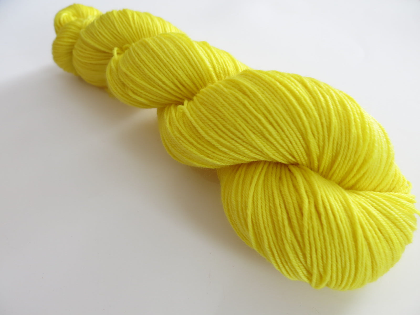 solid yellow sock yarn skein for knitting and crochet
