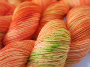 orange indie dyed yarn that glows under black light for festival knits