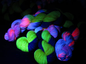 uv reactive yarn frluorescing under black light glowing yellow and pink