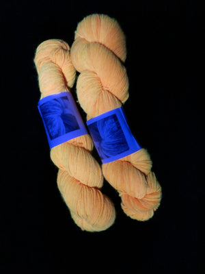 uv reactive orange yarn fluorescing under blacklight