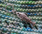 silver fish charm on a snagless ring for knitting projects
