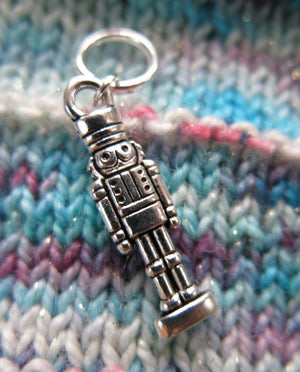silver nutcracker charm on a snagless jump ring for knitting
