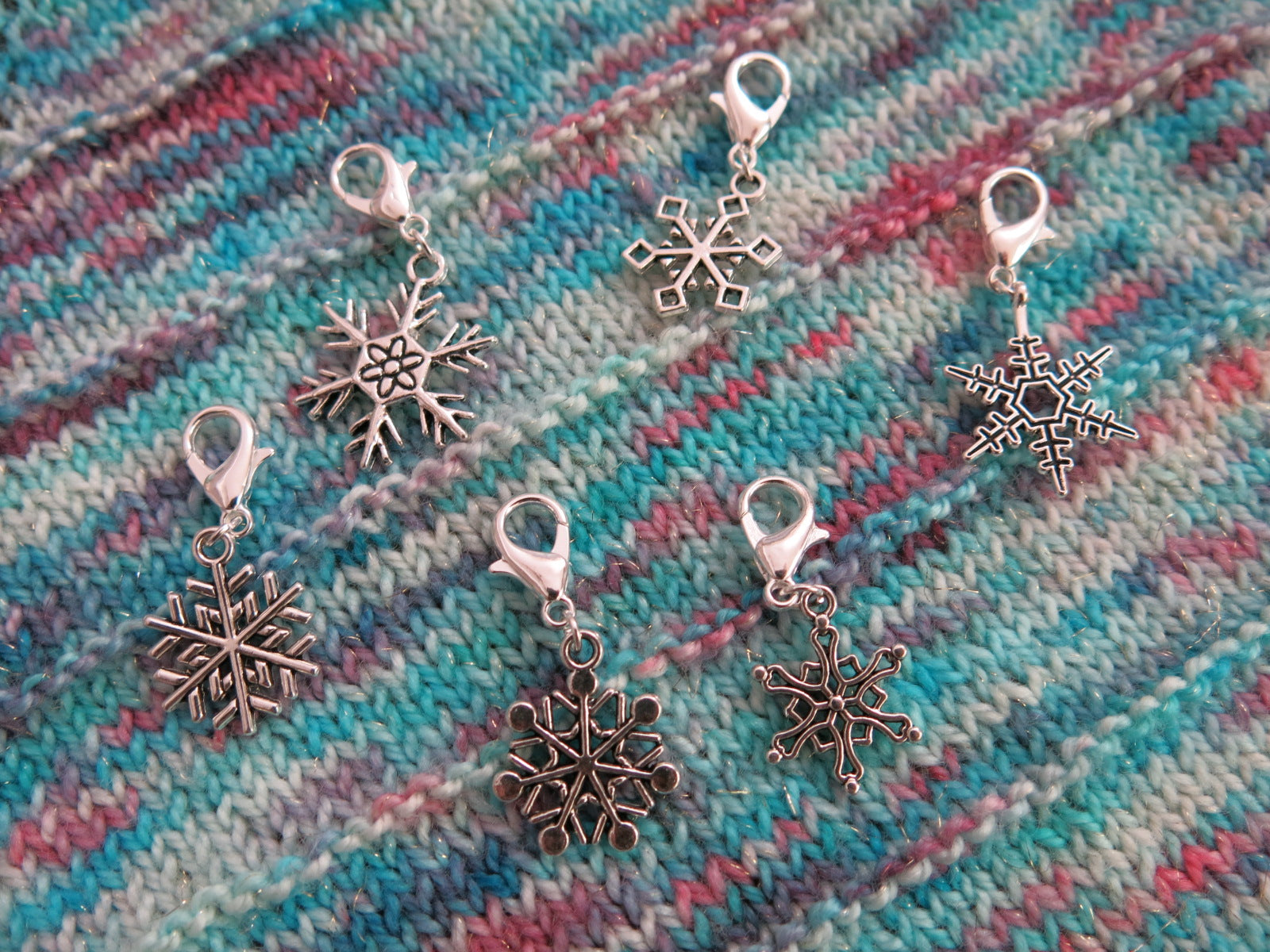 set of snowflake charms on lobster clasps for knitting and crochet