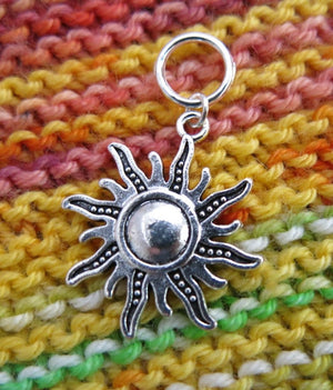 silver hanging sun charm on a snagless jumpring for knitting