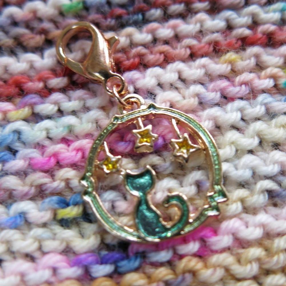 green glitter cat charm with stars on a rose gold lobster clasp