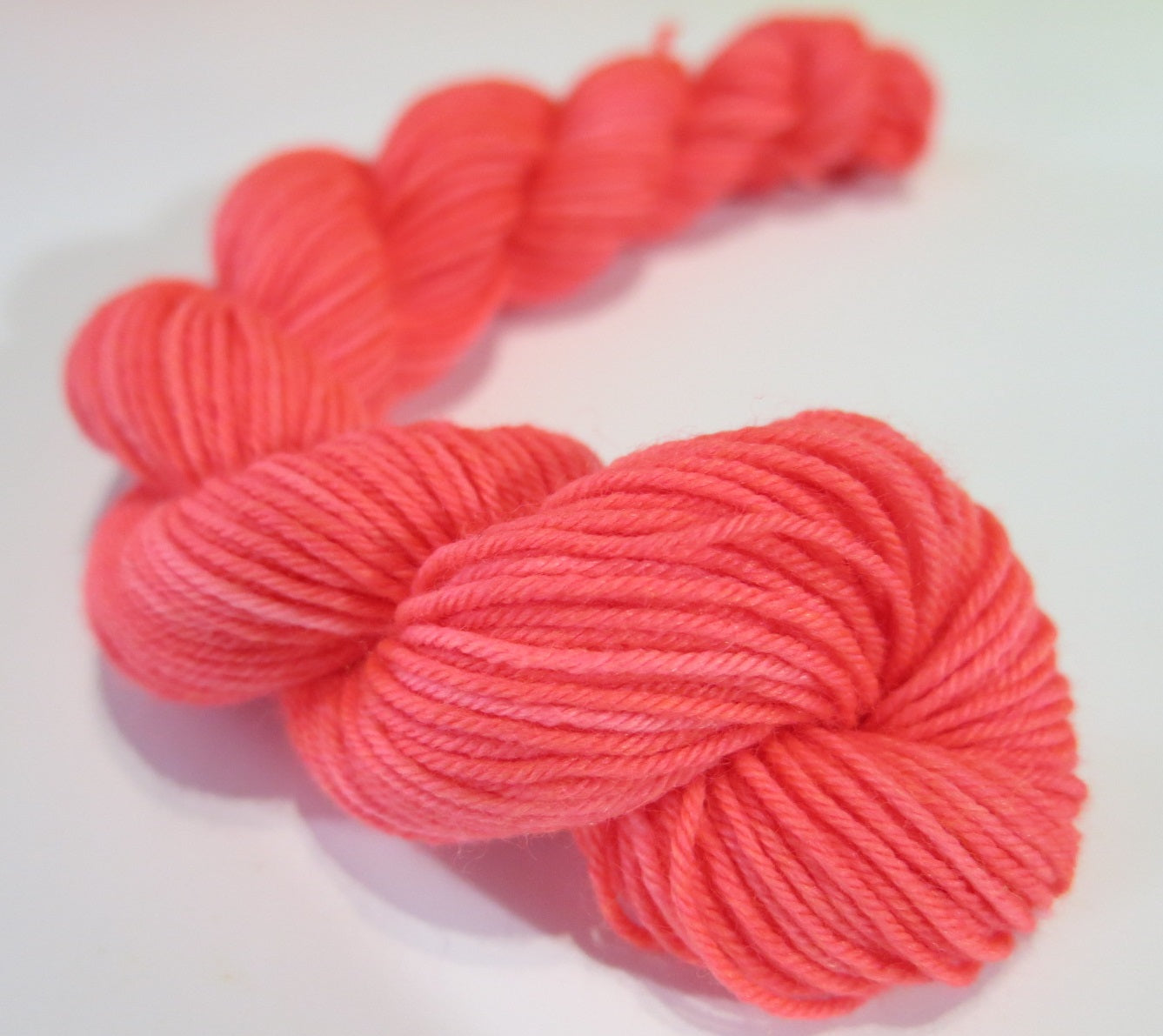 neon coral uv reactive 20g mini yarn skein for knitting and crochet