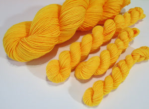 indie dyed orange black light yarn by my mama knits