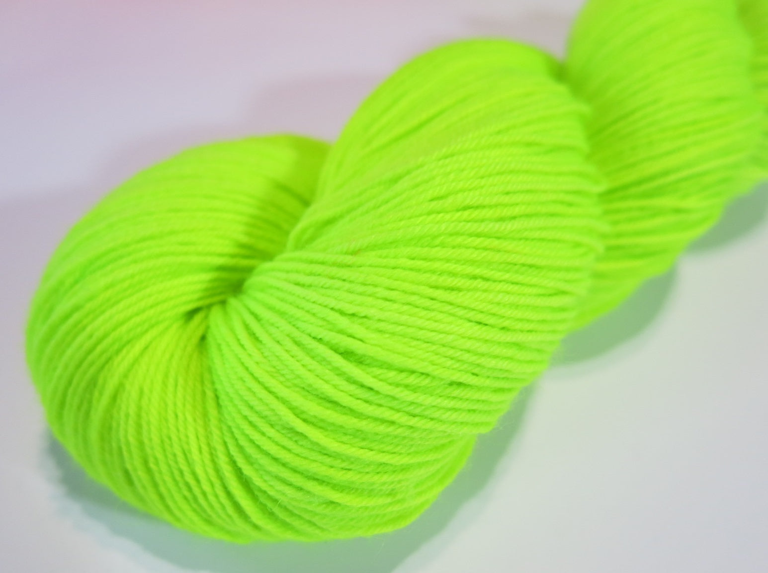 neon green highlighter yellow sock yarn skein for knitting and crochet