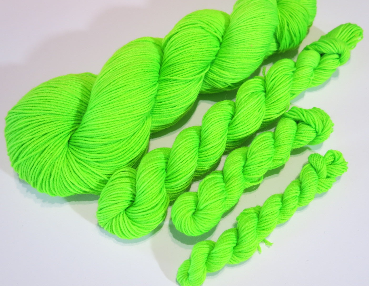 hand dyed neon green uv reactive yarn skeins for knitting and crochet