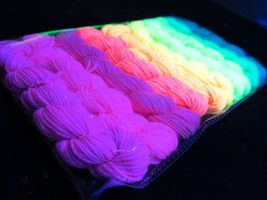 hand dyed uv reactive yarn glowing under black light