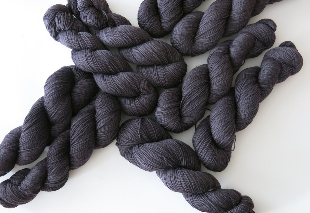 hand dyed solid black sock yarn skeins for halloween knitting and crochet
