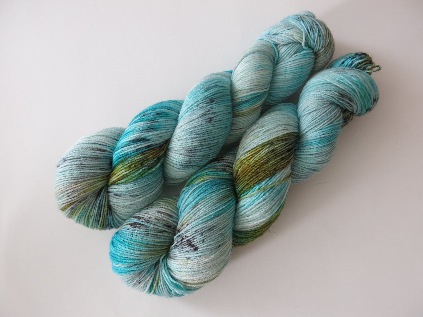 indie dyed speckled turquoise blue sock yarn in 100g skeins
