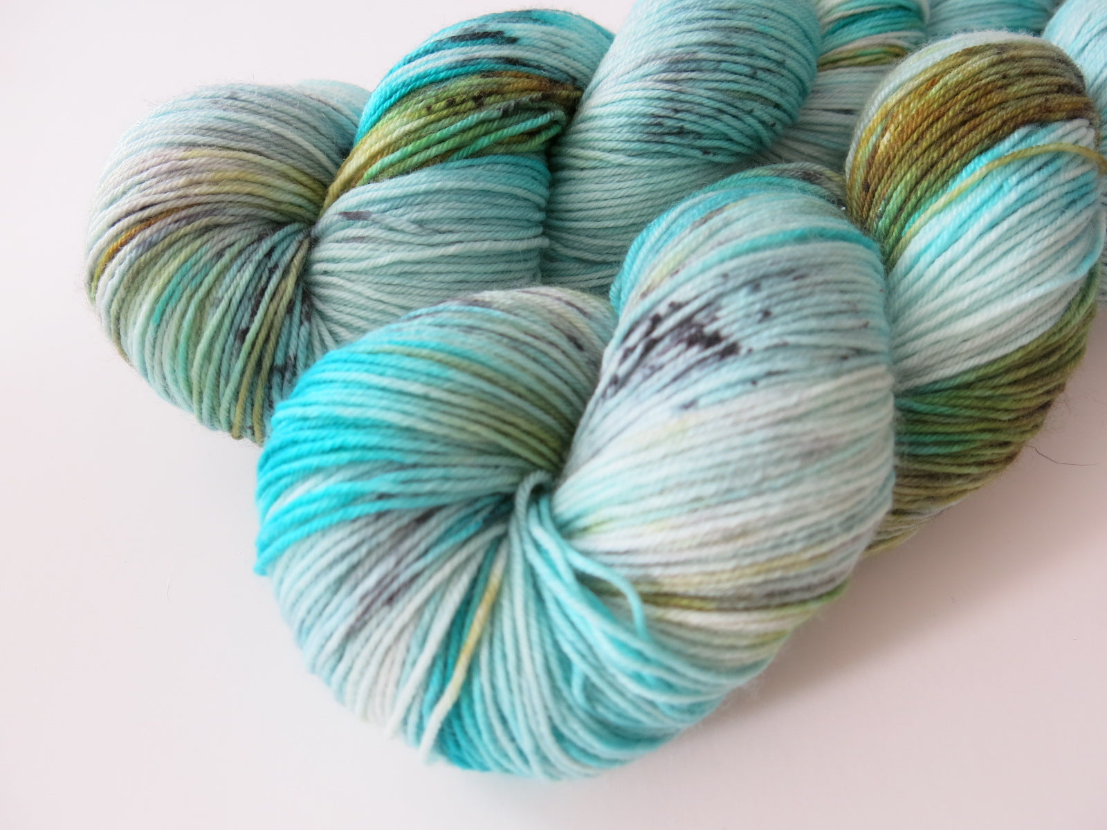 hand dyed green and blue speckled merino wool for sock knitting