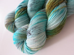 kettle dyed turquoise and speckles sock yarn skein for knitting and crochet