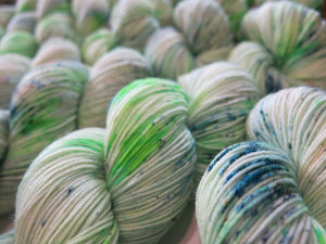 speckled uv reactive green yarn skeins for knitting, embroidery and crochet