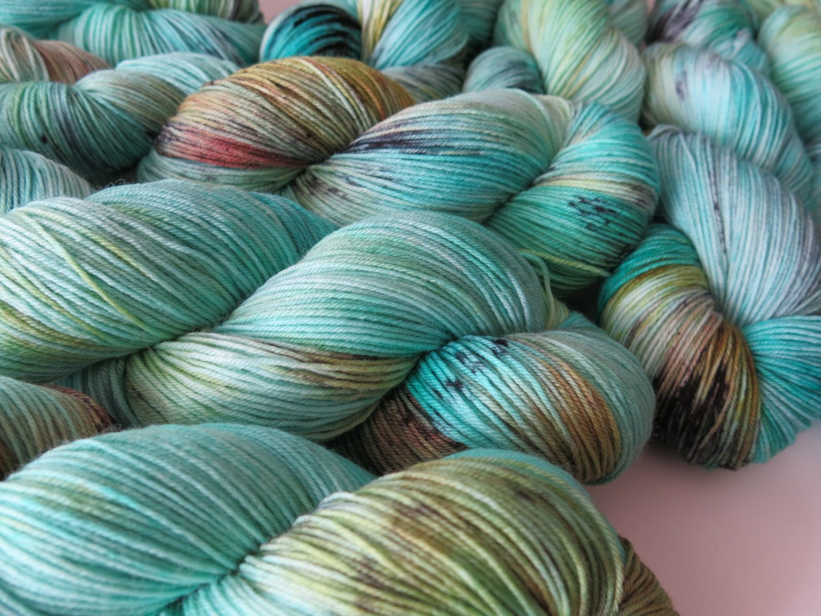 100g skeins of superwash merino and nylon sock yarn in turquoise