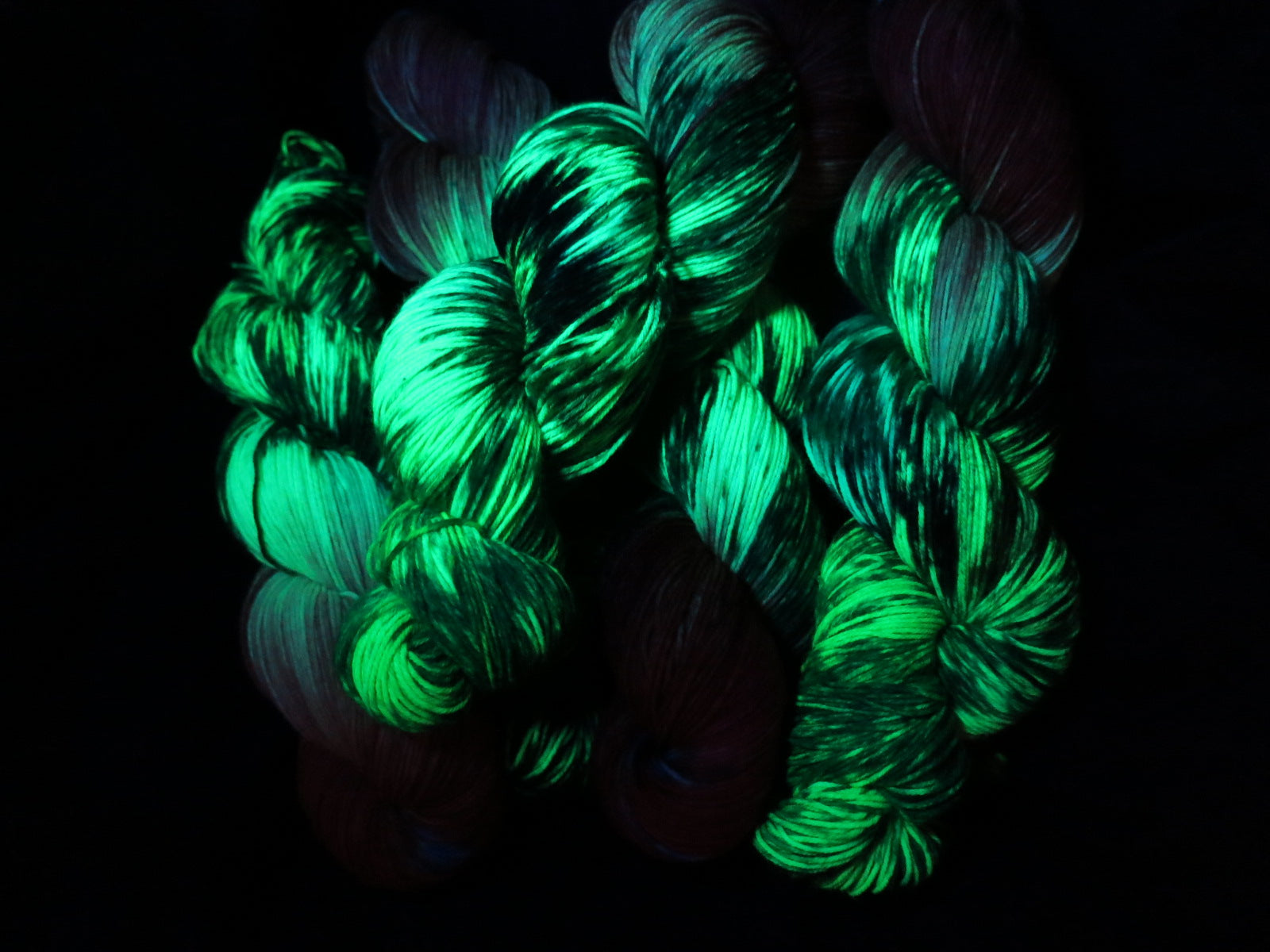 uv reactive hungry caterpillar yarn fluorescing under black light