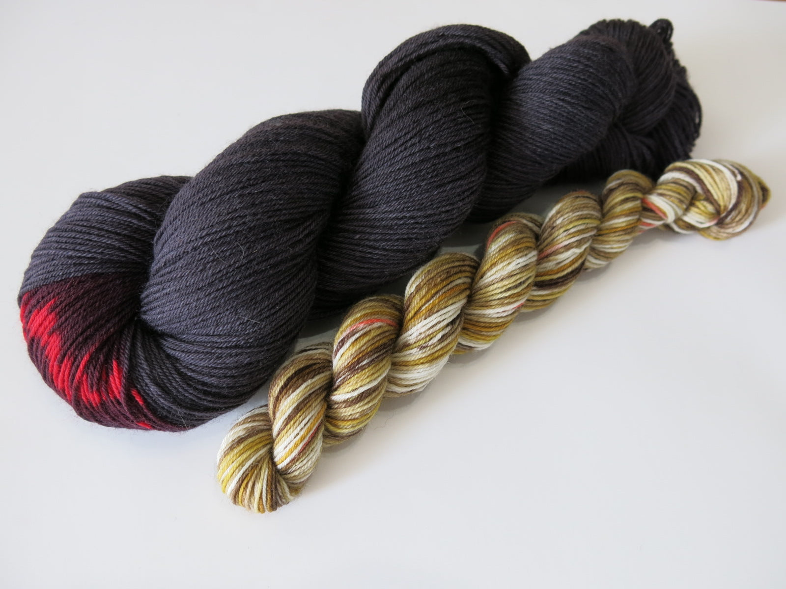 merino sock yarn skeins inspired by male and female black widow spiders