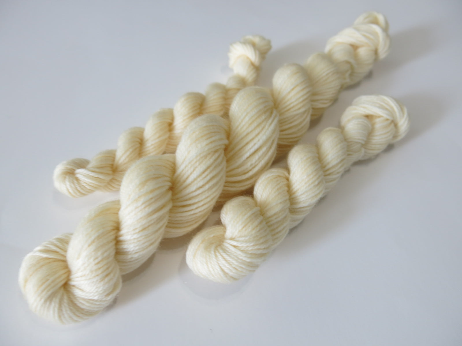 pastel ivory coloured merino sock yarn mini skein for knitting and crochet