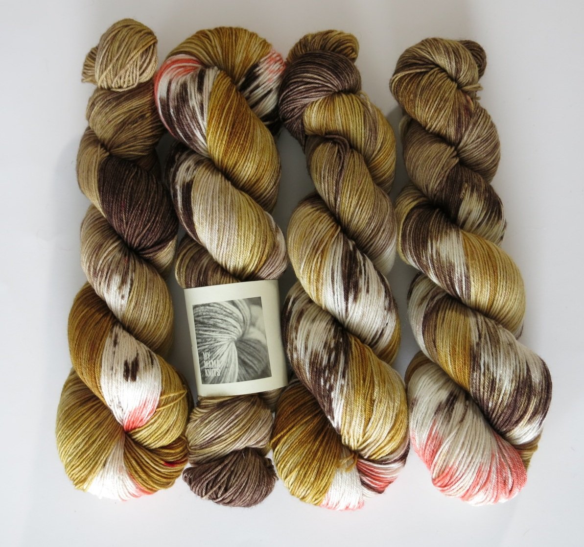 hand dyed yarn inspired by male black widow spiders in browns and coral