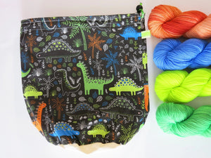 cotton drawstring knitting project bags with cartoon dinosaurs with a brown background