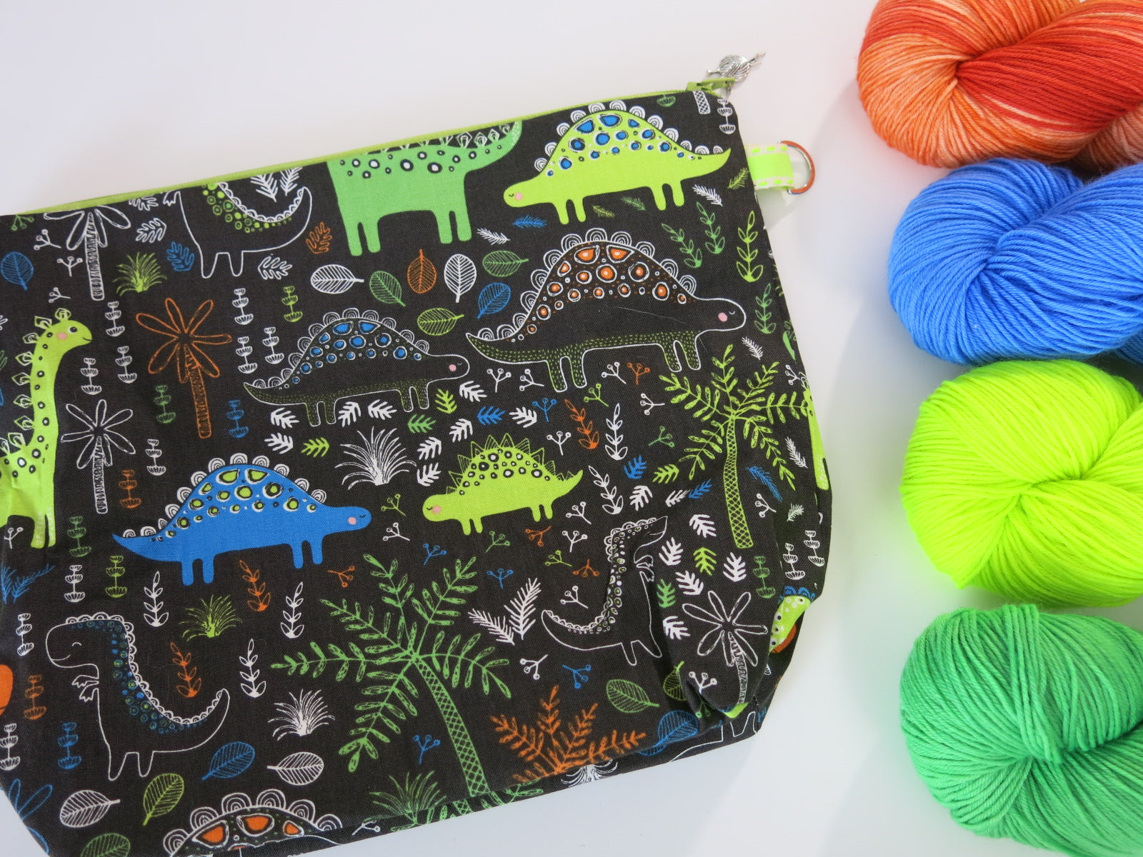 cotton zippered knitting project bags with cartoon dinosaurs with a brown background